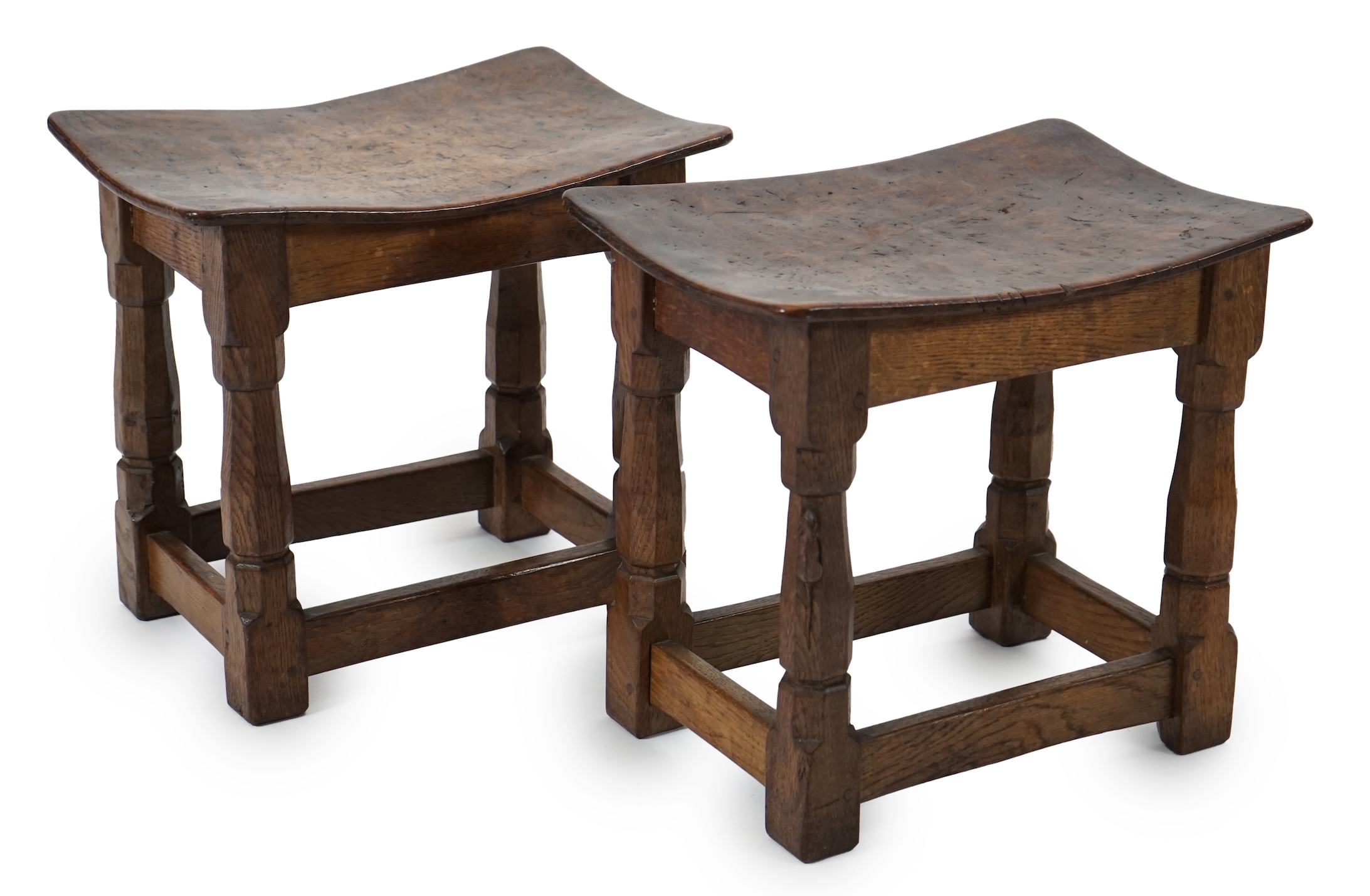 A pair of Robert 'Mouseman' Thompson burr oak stools, 1930s